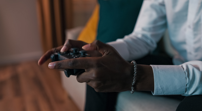 Person using a game controller to play a video game console.