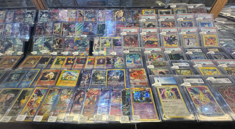 Pokémon trading cards, including graded cards and collectible sets.