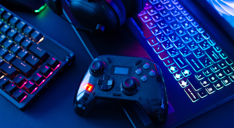 Video game controller and gaming setup representing video games and gaming accessories.